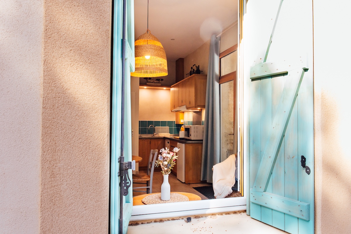 Depuis la cour du domaine viticole, la vue sur le salon bleu du gîte pour 2 personnes